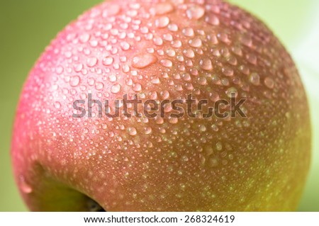 Drops on a red apple. Top view close-up