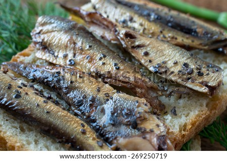Smoked fish on bread with dill in a rustic style
