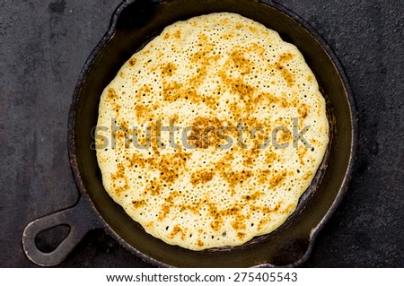 Russian pancake blin in a frying pan. Top view