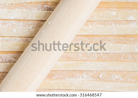 Cooking pasta rolling pin on the table view from above