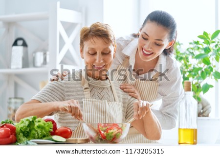 Healthy food at home. Happy family in the kitchen. Mother and daughter are preparing the vegetables.