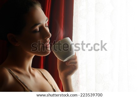 Woman with an aromatic coffee in hand