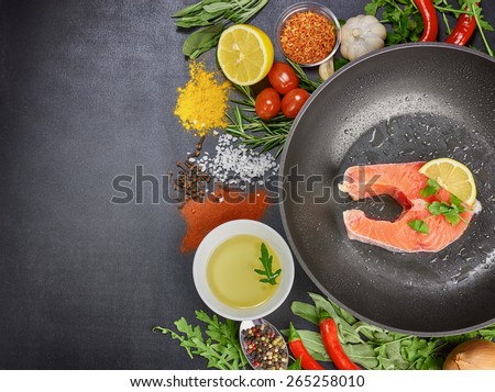 fish and vegetables on a black background