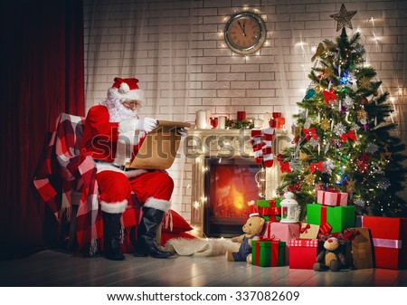 Portrait of Santa Claus sitting at his room at home near Christmas tree