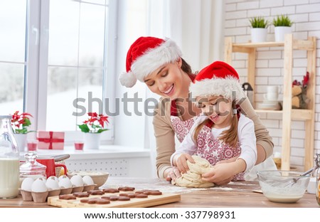 mother and daughter cooking Christmas biscuits