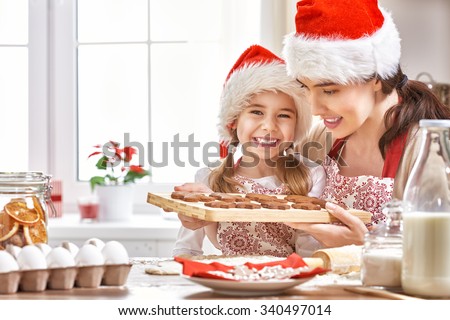 mother and daughter cooking Christmas biscuits