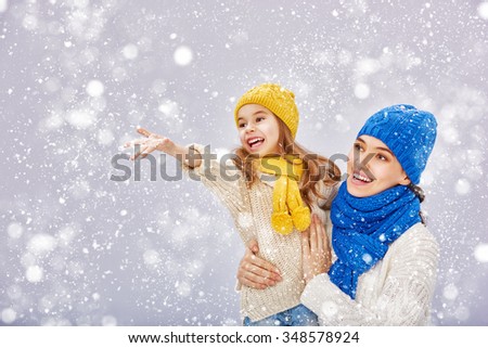 Happy family! Mother and child girl on a winter walk.