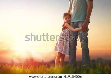 Happy loving family. Father and his daughter child girl playing and hugging outdoors. Cute little girl hugs daddy. Concept of Father\'s day.