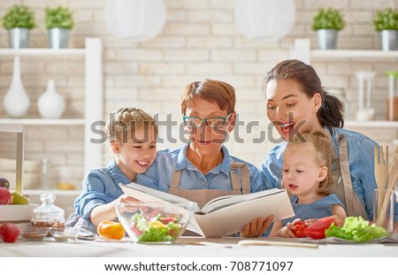 Healthy food at home. Happy family in the kitchen. Grandma, mother and children daughters are preparing the vegetables and fruit.