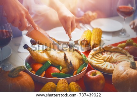 Happy Thanksgiving Day! Autumn feast. Family sitting at the table and celebrating holiday. Traditional dinner. Parents and children.
