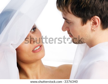 A white girl and  a white man standing together on a white background
