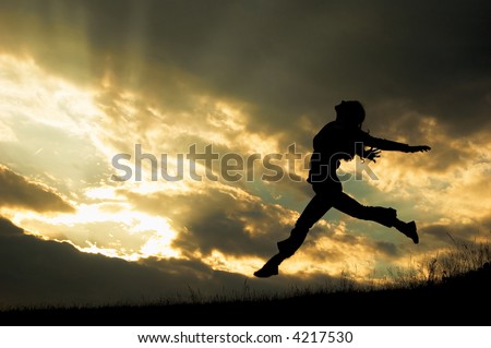 a jumping girl on the sunset background