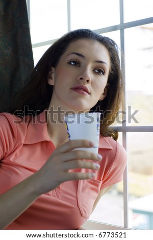 girl with a mug at the window