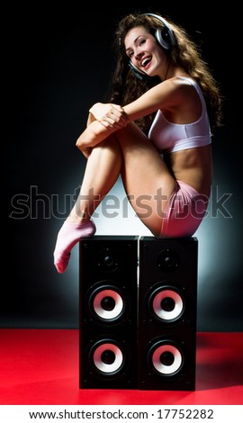 young beautiful girl listening music with pleasure