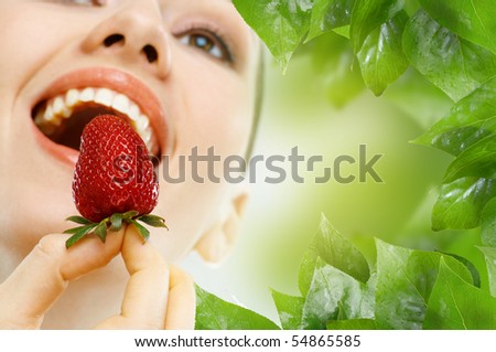 a beauty woman enjoying a fresh strawberry