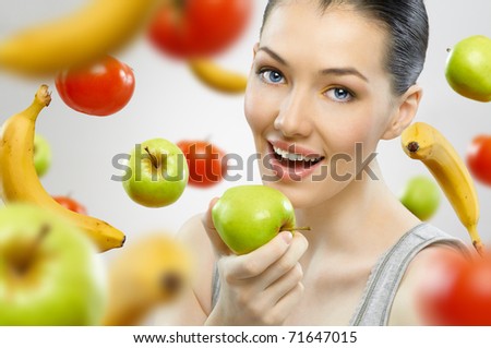 stock photo A beautiful slender girl eating healthy fruit