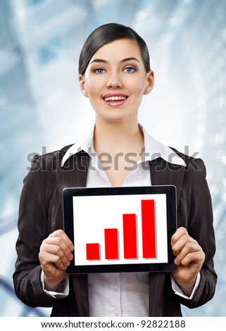 a woman holding a tablet pc