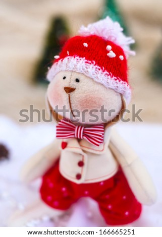 Christmas toy rabbit on background trees. Property released