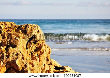 Seascape - with a big stone of a shell rock, easy waves and the quiet sky.