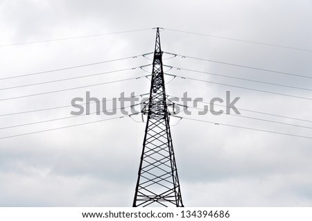 Power line against the background of the cloudy sky.