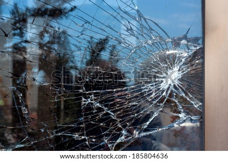 Broken Glass with outdoor street reflection. Closeup.