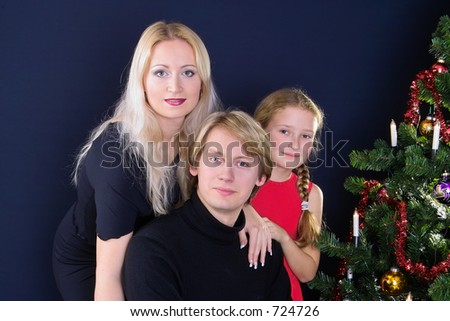 happy family under decorated christmas tree