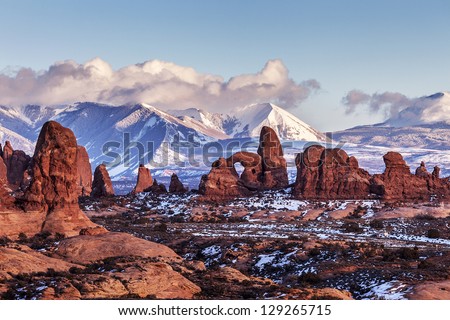 Turret Arch with Snow Mountains at sunset. Arches National Park, Utah