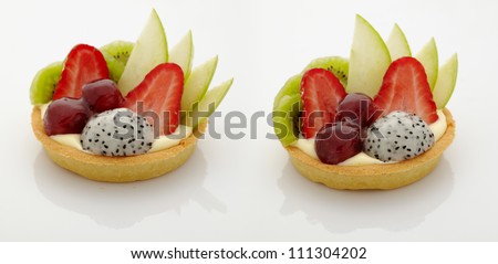 mixed fruit tart ; strawberry, grape, kiwi, apple and dragon fruit ; on white background with reflect under studio light