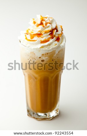 cappuccino frappe with whipping cream and butterscotch topping on white background