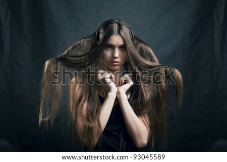portrait of a beautiful woman with perfect hair on a dark background