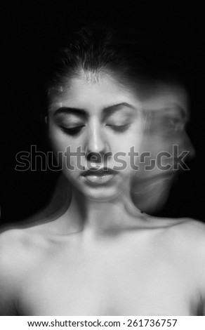 Attractive sexy young woman with posing on the black background. Black-and-white photo. Fashion photo. Portrait of beautiful sensual woman