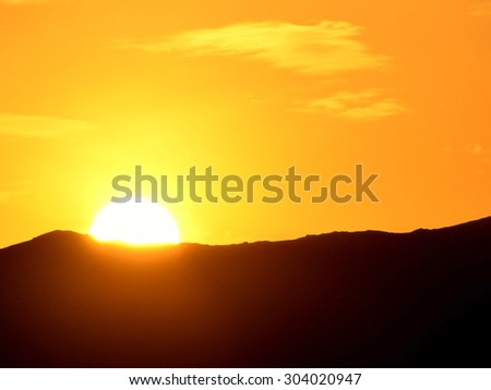 Sun setting over hills