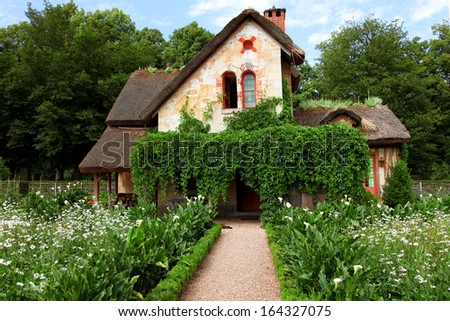 VERSAILLES - JULY 11: Cottage at Marie Antoinette\'s Little Hamlet, rustic retreat in the park of the Palace of Versailles near the Petit Trianon on July 11, 2010 in Versailles.