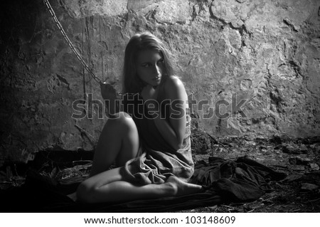 Portrait of young feared girl in prison with neck chain