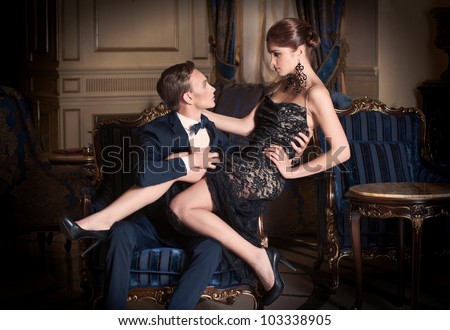 http://image.shutterstock.com/display_pic_with_logo/919469/103338905/stock-photo-date-man-in-suit-and-woman-in-evening-dress-sitting-on-his-lap-103338905.jpg