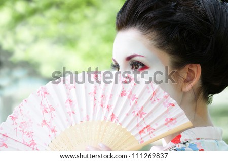 Portrait of young woman with geisha style makeup