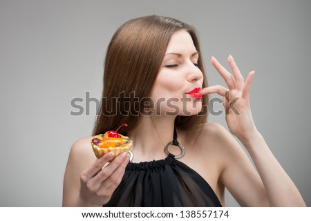 Portrait of young woman enjoying the cake
