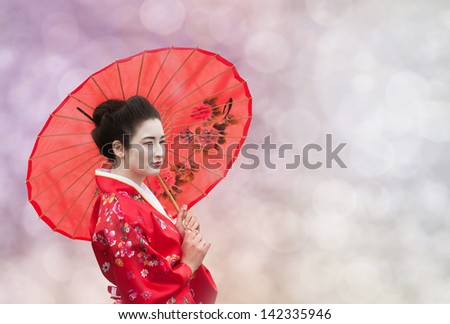 Asian style portrait of a woman with red umbrella on abstract background