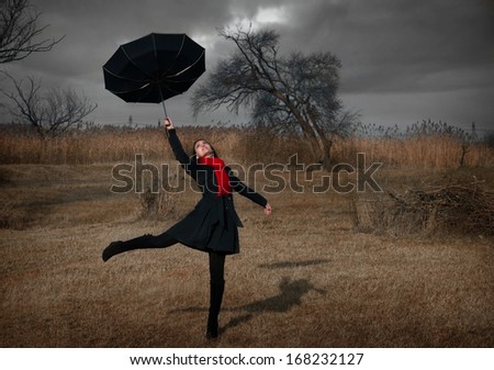 Woman with umbrella turning inside out by the wind