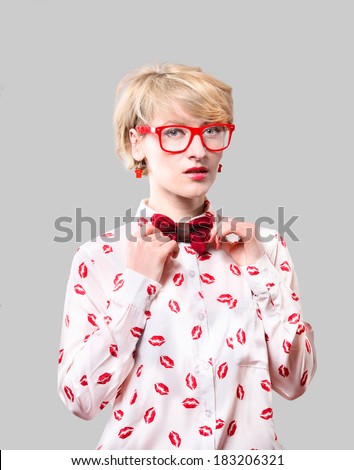 Portrait of a old fashioned blonde woman adjusting a tie