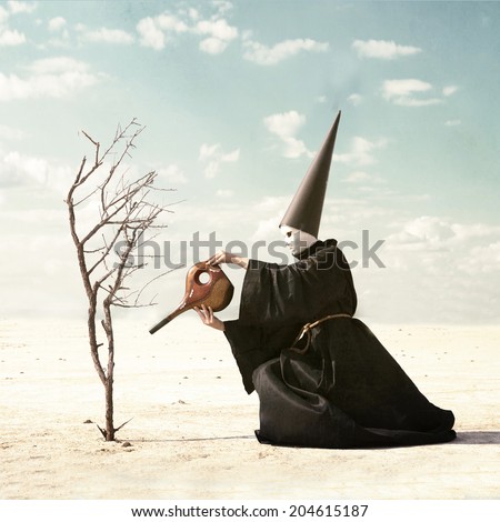 Mysterious person in the mask and the dunce hat watering a dry plant from the empty vessel