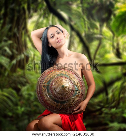 Portrait of a pretty woman with bamboo hat, jungle background