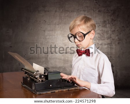 Boy with the typewriter. Retro style portrait