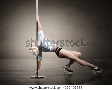 Pole dancer, blond woman dancing on pylon