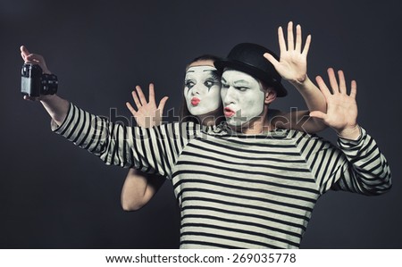 Funny couple of mimes taking a selfie photo
