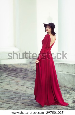 Woman in the long red dress looking back