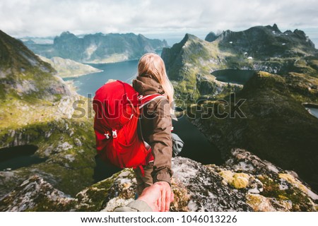 Couple follow holding hands on cliff mountain in Norway Travel lifestyle love emotions concept summer vacations family outdoor Lofoten islands