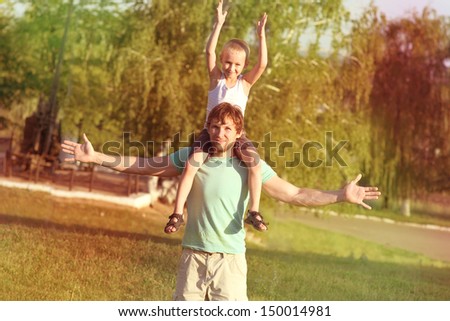 Family Father Man and Son Boy sitting on shoulders playing Outdoor park Happiness emotion with summer nature on background