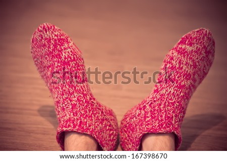 Man Legs In Red Wool Socks Male Knitted Clothes Winter Handmade Accessories Home Comfort Concept On Wooden Background Trendy Colors