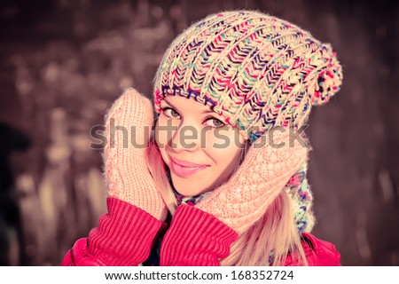 Winter Woman Beautiful happy smiling Face wearing knitted hat and scarf with mittens Lifestyle concept and Christmas holiday trendy colors
